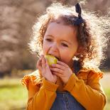 A child biting into an apple